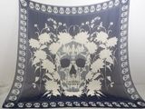 a blanket with a skull and flowers on it
