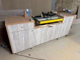 a workbench that has a lot of tools on top of it