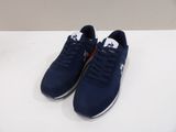 a pair of blue sneakers sitting on top of a white table