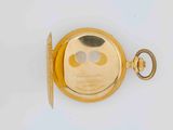 an image of a gold pocket watch with a key on a white surface