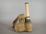 a pair of shoes with a baseball bat sticking out of them