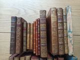 several old books are stacked on top of each other on a table