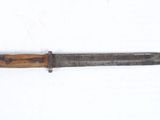 an old knife with a wooden handle on a white surface