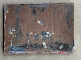 a piece of rust on the side of a building
