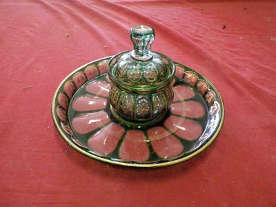 a glass plate with a glass jar on it