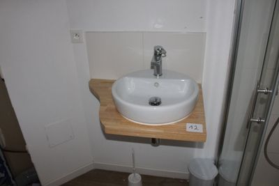a small bathroom with a sink and a shower stall