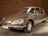 a brown car parked in a garage next to a brick wall