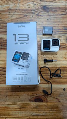 a box with a camera and a charger on a wooden table