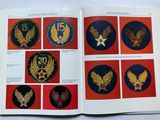 an open book with a picture of different military badges on it