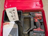 the tool kit is packed in a red case on the floor