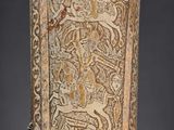 an old carved wooden plaque with a design on it