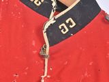 an old red jacket with black and white letters on it