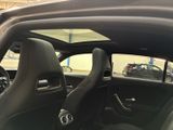 the interior of a car with the door open and the driver ' s seat down