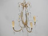 a close up of a chandelier with three lights on it