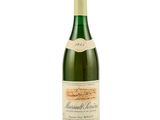 an image of a bottle of white wine on a white surface