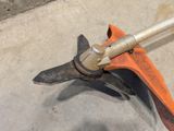an orange and black pipe cutter on a concrete floor