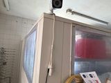 an image of a kitchen with a television and a refrigerator