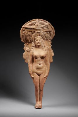 an egyptian terra figure of a woman with a basket on her head