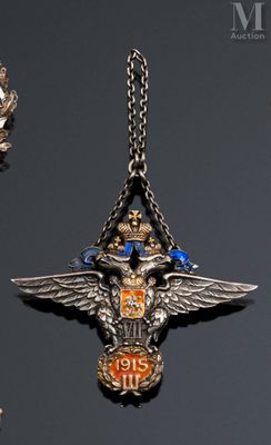three silver and gold medals are displayed on a black surface