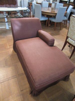 a chaise lounger in the middle of a large room