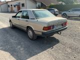 a car that is parked in a lot near a house