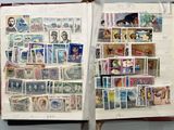an open book with stamps on the pages and a picture of a man