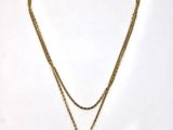 a close up of a necklace with a lock on a chain