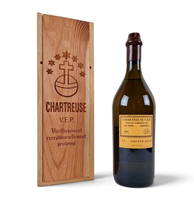 the bottle of wine is next to a wooden box