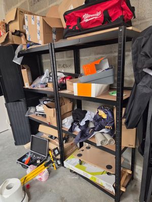 many boxes and boxes on the shelves in the garage