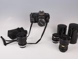 a camera and some other items on a white surface