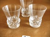 three shot glasses sitting next to each other on a table