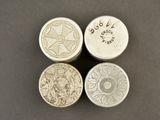 three silver coins sitting on top of each other on top of a table