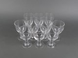 six clear wine glasses sitting on top of each other on a table