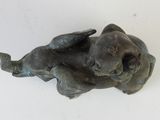 a small statue of a bear laying on its back