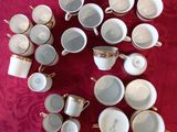 a lot of cups and saucers sitting on a table