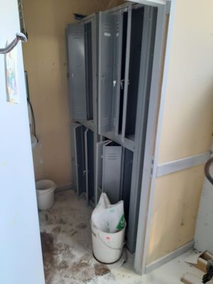 a trash can in the corner of a bathroom that is being remodeled