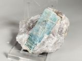 a piece of rock with a blue stone on it