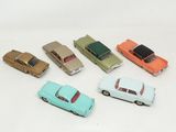 several toy cars are lined up in a row on a white surface