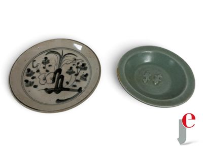 two plates with designs on them sitting next to each other