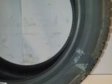tire of a truck with a flat tire on a white surface
