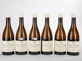 six bouteilles de vin sont alignées sur une table