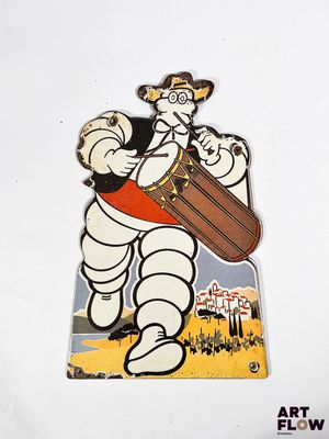 an image of a pin with an image of a man in a hat playing a drum