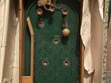 a picture of a green door with bells on it