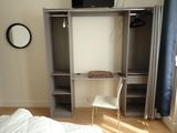 a small bedroom with a bed and a television on a stand