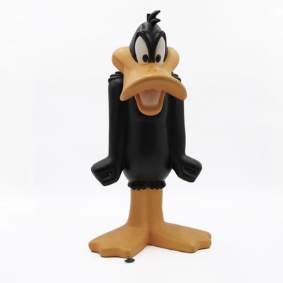 the toy figure of a goofy duck is posed on a white surface