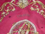 a picture of a pink table cloth with a gold design