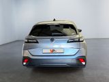 the rear end of a silver car in a white room