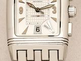 a close up of a silver watch on a white surface