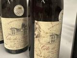 several bottles of wine are lined up on a table