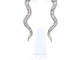 a pair of diamond earrings on a stand on a white background